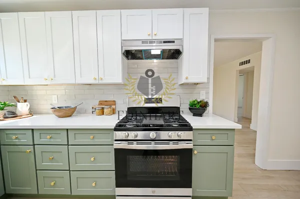 a stove top oven sitting inside of a kitchen