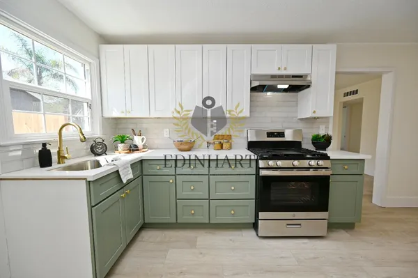 a kitchen with stainless steel appliances granite countertop a sink stove and cabinets