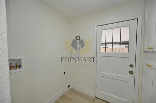 a view of an entryway with wooden floor