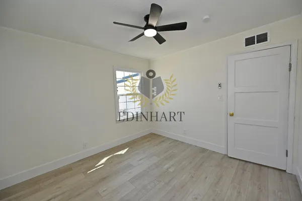 a bathroom with a sink vanity mirror and tub