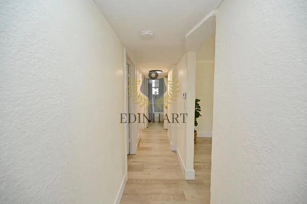 a view of a house with a wooden fence