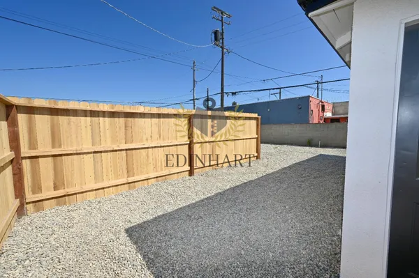 a view of a hallway with wooden floor and windows