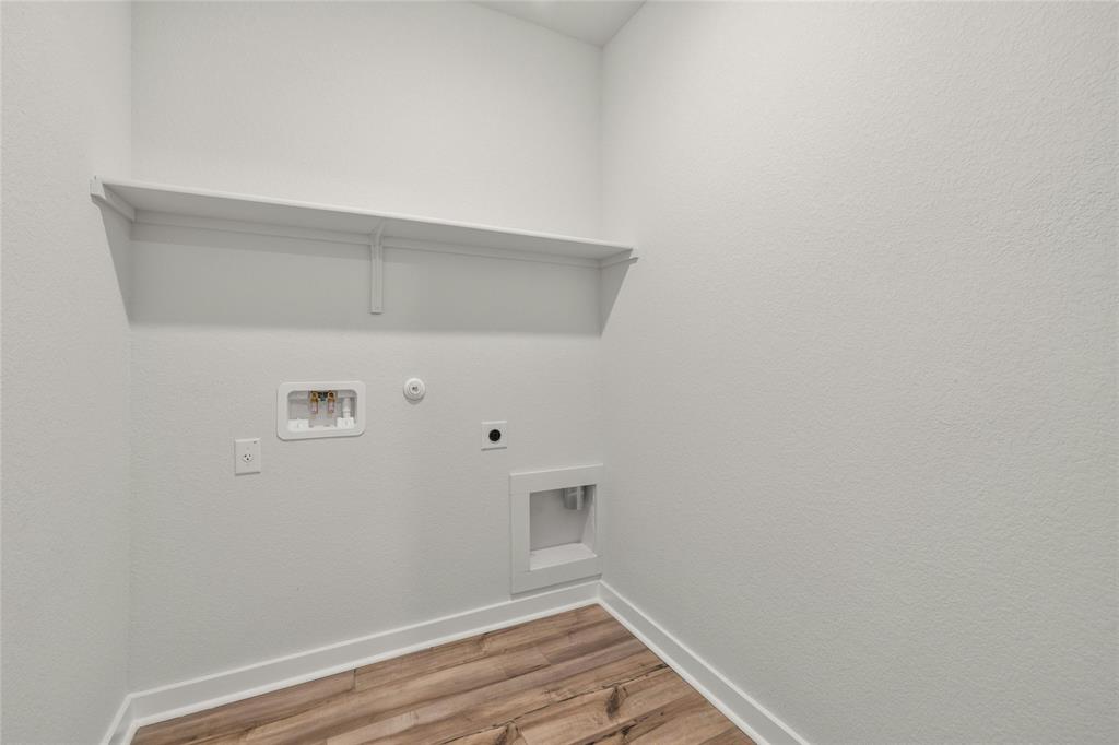 113 Shadow Oak Cove Georgetown, TX 78628 - Photo 35 of 40 A dedicated utility space with essential hookups and a convenient shelf for all laundry needs.