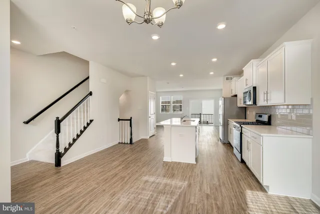 a view of kitchen with sink and wooden floor