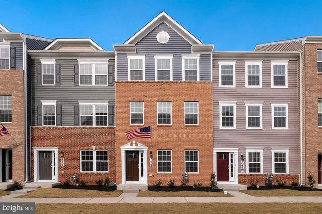 a front view of a building with a yard