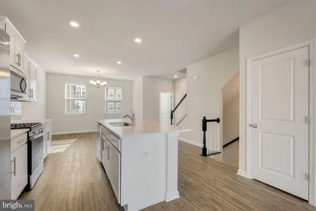 a view of a kitchen with furniture and wooden floor