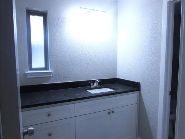 a bath room with a toilet a sink and a shower