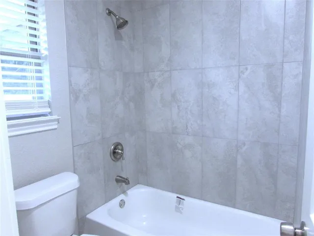 a bathroom with a toilet and a bathtub