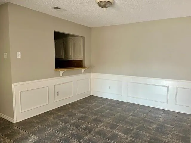 a kitchen with granite countertop white cabinets and black appliances