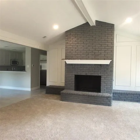 a view of empty room with a fireplace