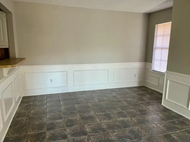 a view of an empty room and a window