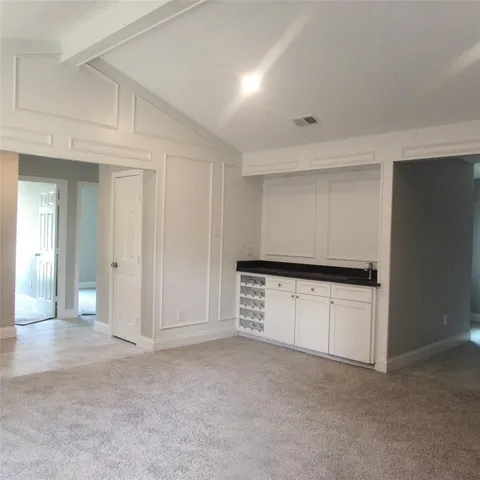 wooden floor in an empty room with a kitchen