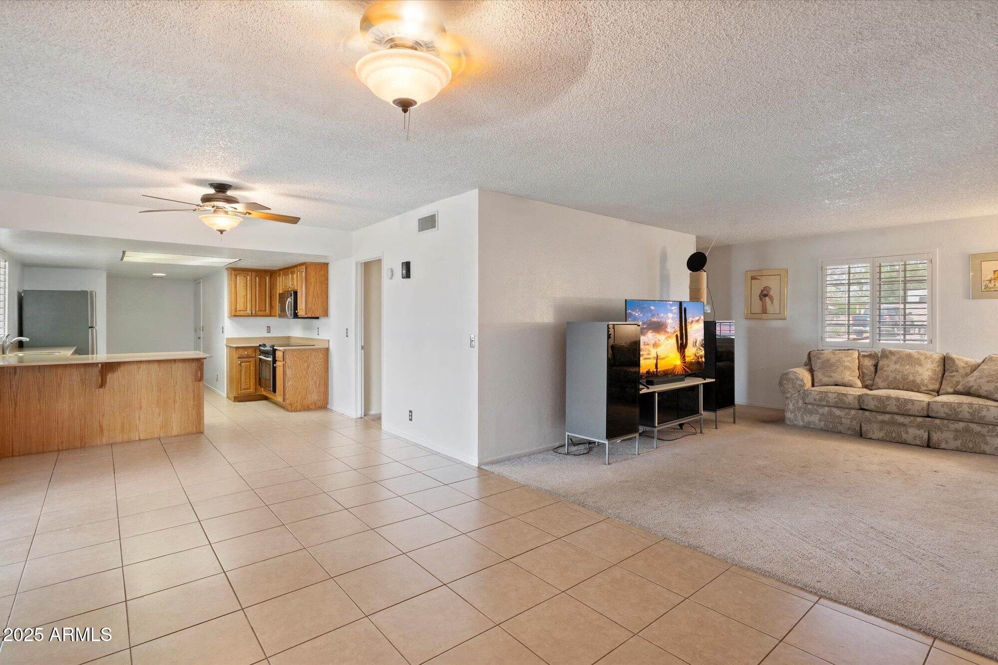 a view of a livingroom with furniture and a kitchen area