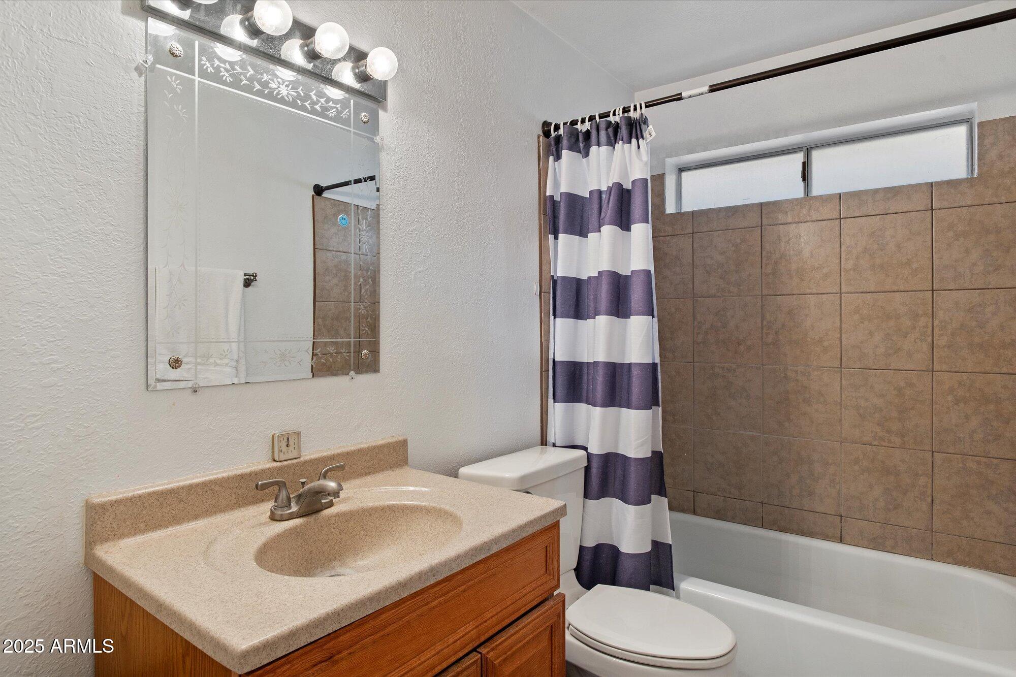 4333 East Desert Cactus Street Phoenix, AZ 85032 - Photo 11 of 18 a bathroom with a sink toilet and shower