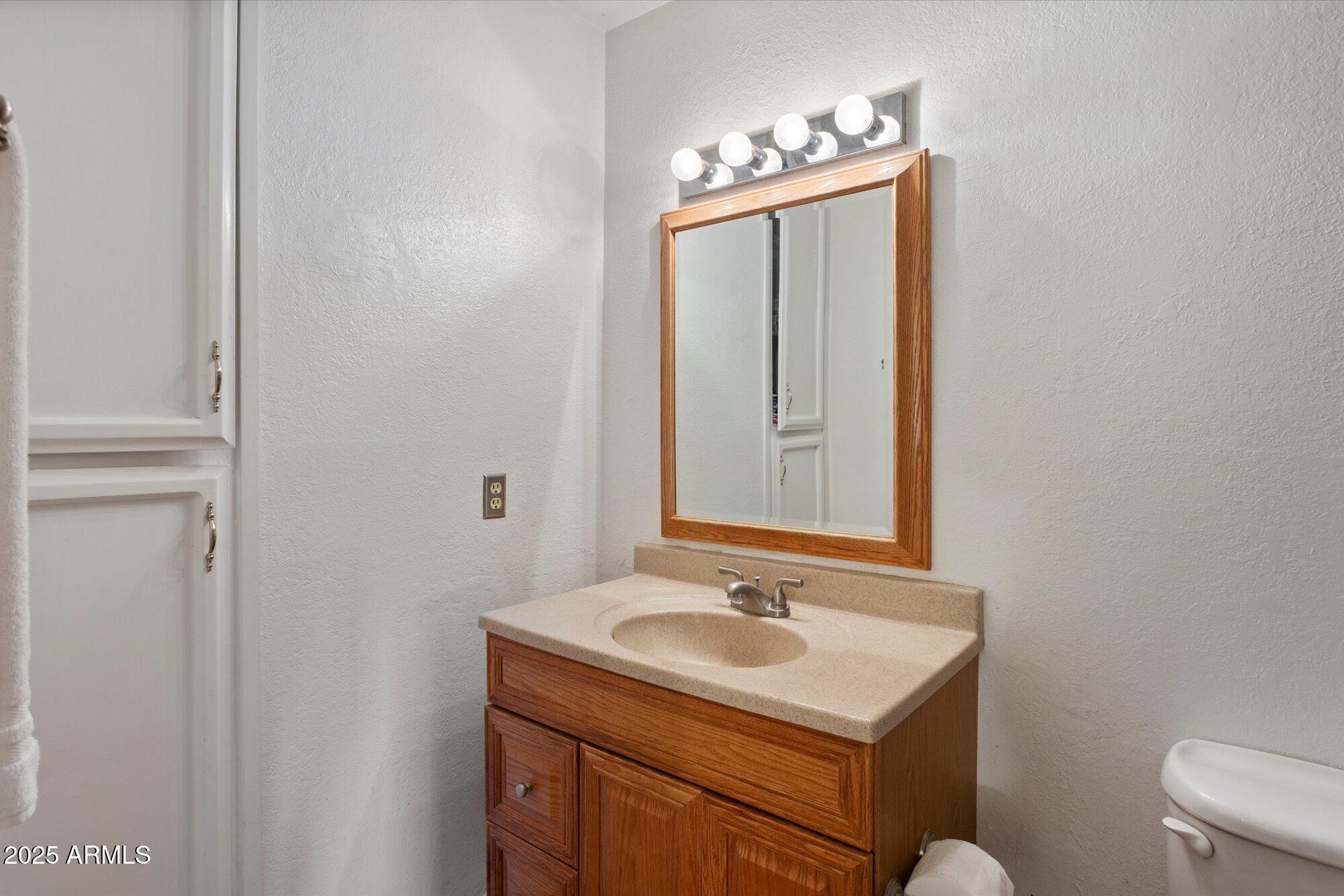 4333 East Desert Cactus Street Phoenix, AZ 85032 - Photo 12 of 18 a bathroom with a sink toilet and mirror