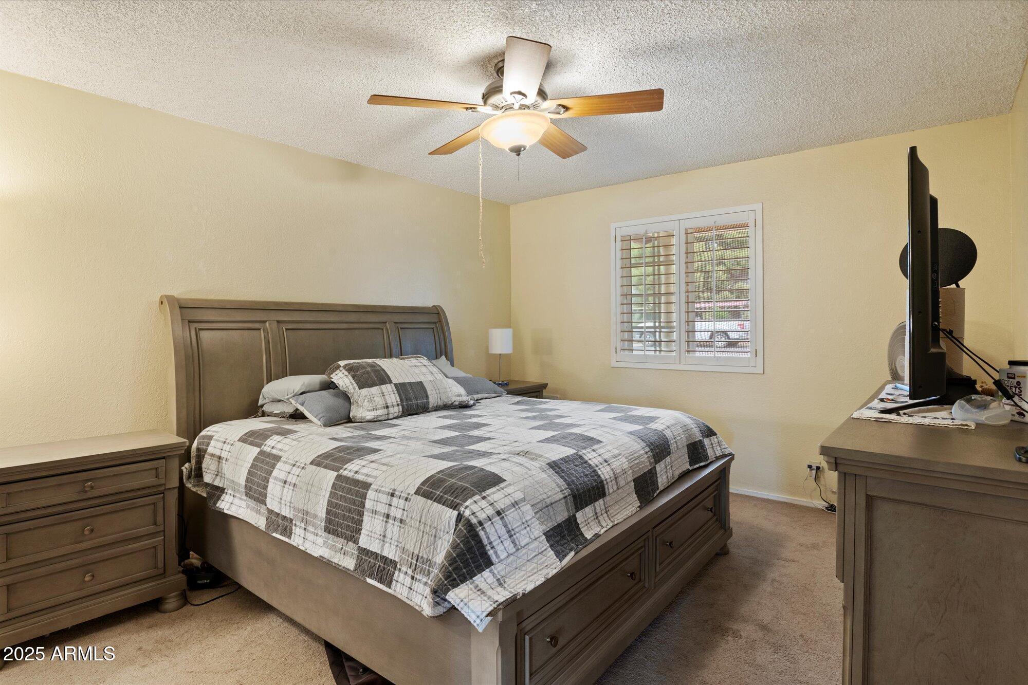 4333 East Desert Cactus Street Phoenix, AZ 85032 - Photo 13 of 18 a bedroom with a bed and a chandelier