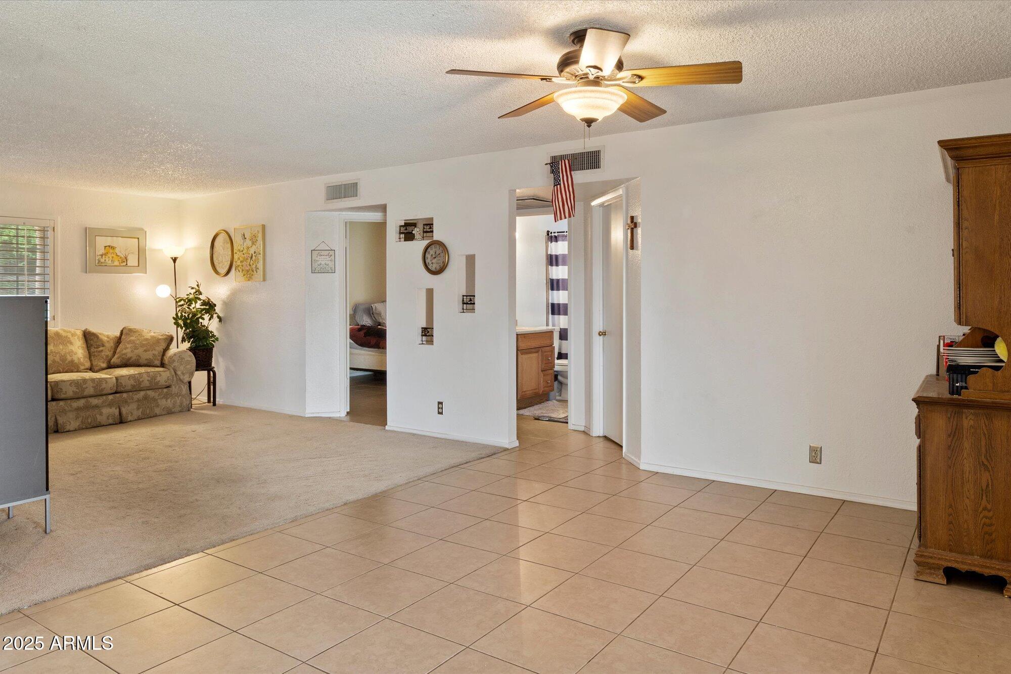 4333 East Desert Cactus Street Phoenix, AZ 85032 - Photo 8 of 18 a view of a livingroom with furniture and a ceiling fan