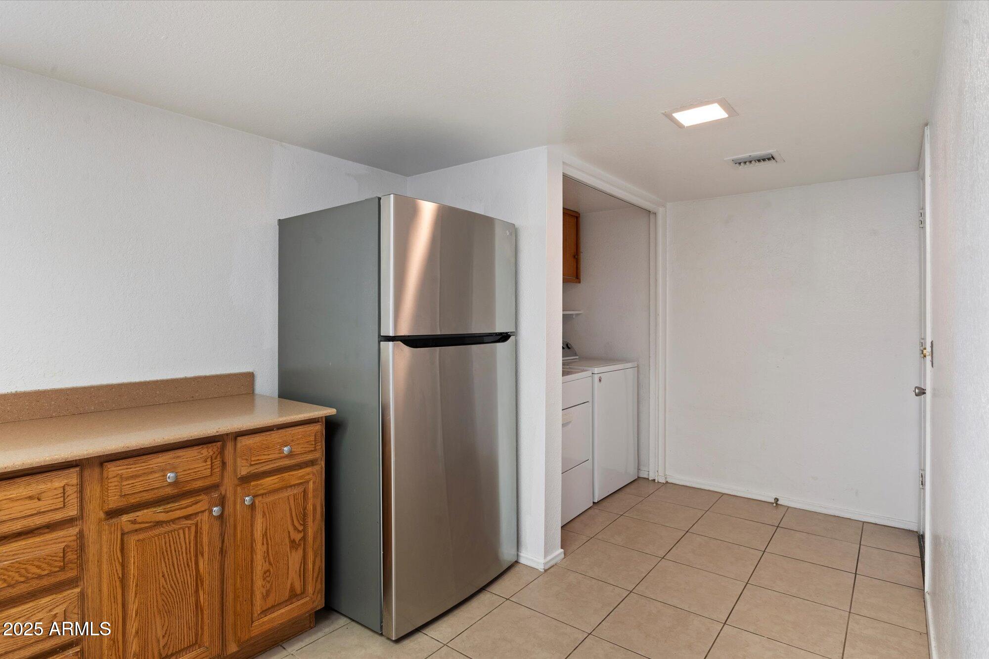 4333 East Desert Cactus Street Phoenix, AZ 85032 - Photo 10 of 18 a kitchen with a refrigerator and a sink