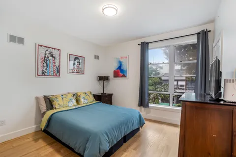 a bedroom with a large bed and a large window