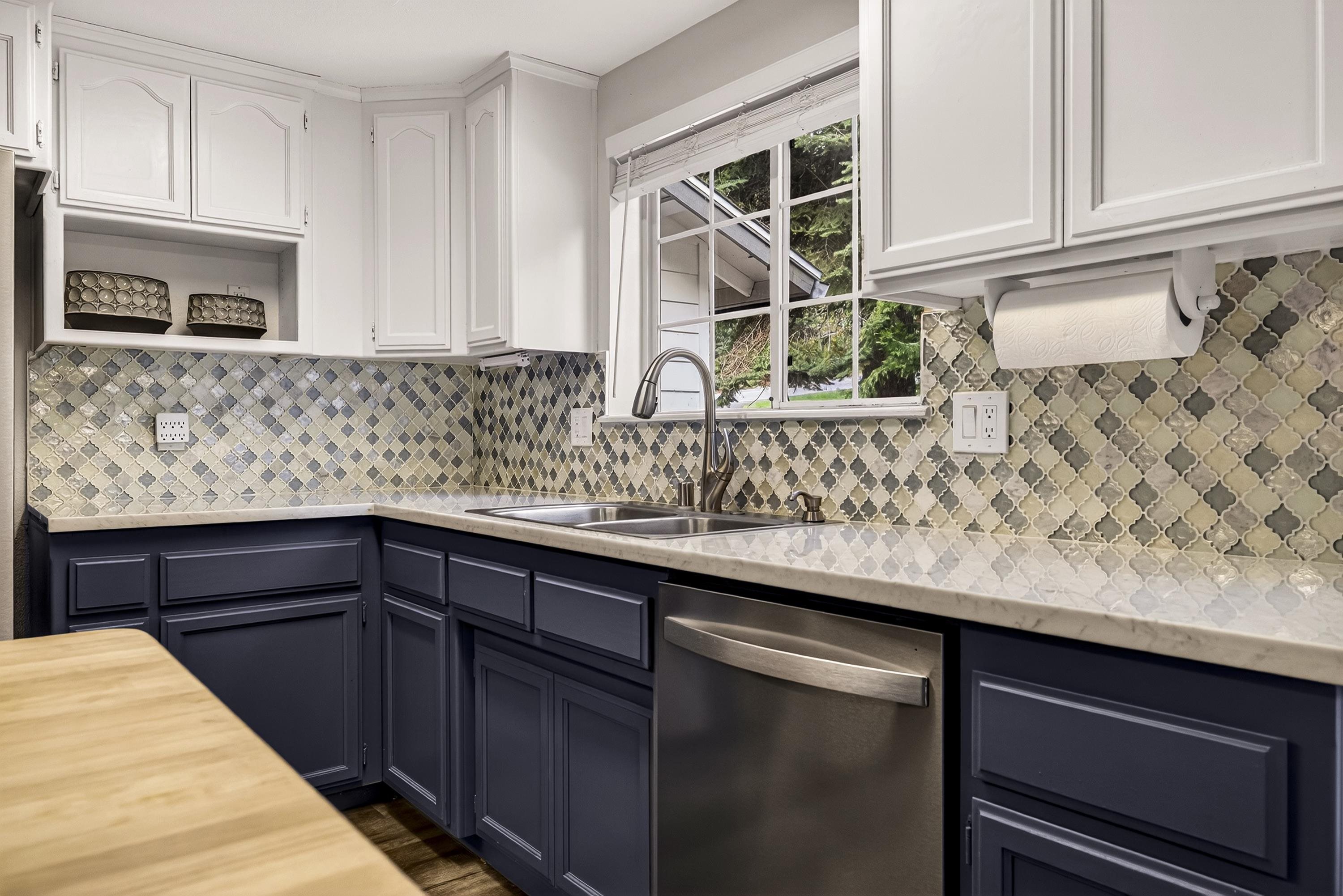 811 Golf Club Road Lake Almanor, CA 96137 - Photo 11 of 42 a kitchen with stainless steel appliances kitchen island granite countertop a sink and cabinets