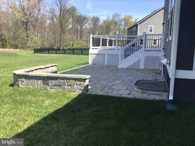 a view of a house with a yard porch and sitting area