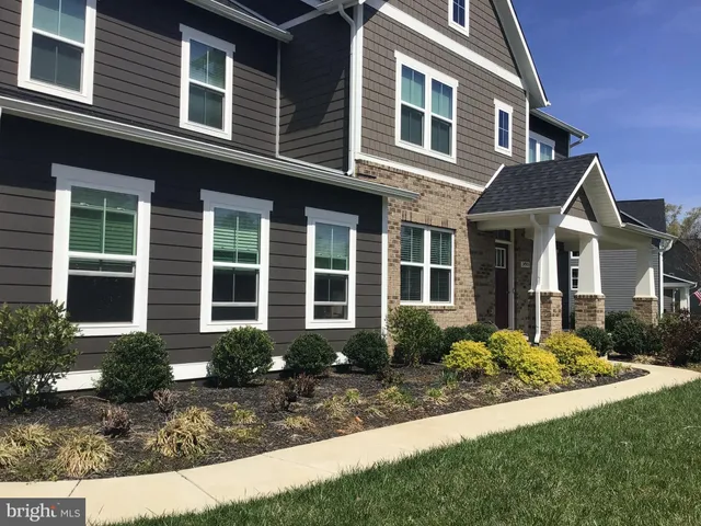 a front view of a house with garden and porch