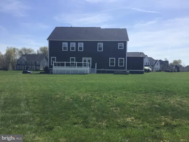 a view of a house with a yard and sitting area