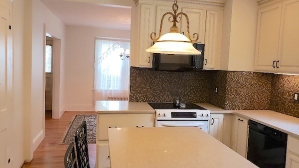 45 Wachusett Street Springfield, MA 01118 - Photo 6 of 23 a kitchen with stainless steel appliances a stove a sink and a refrigerator
