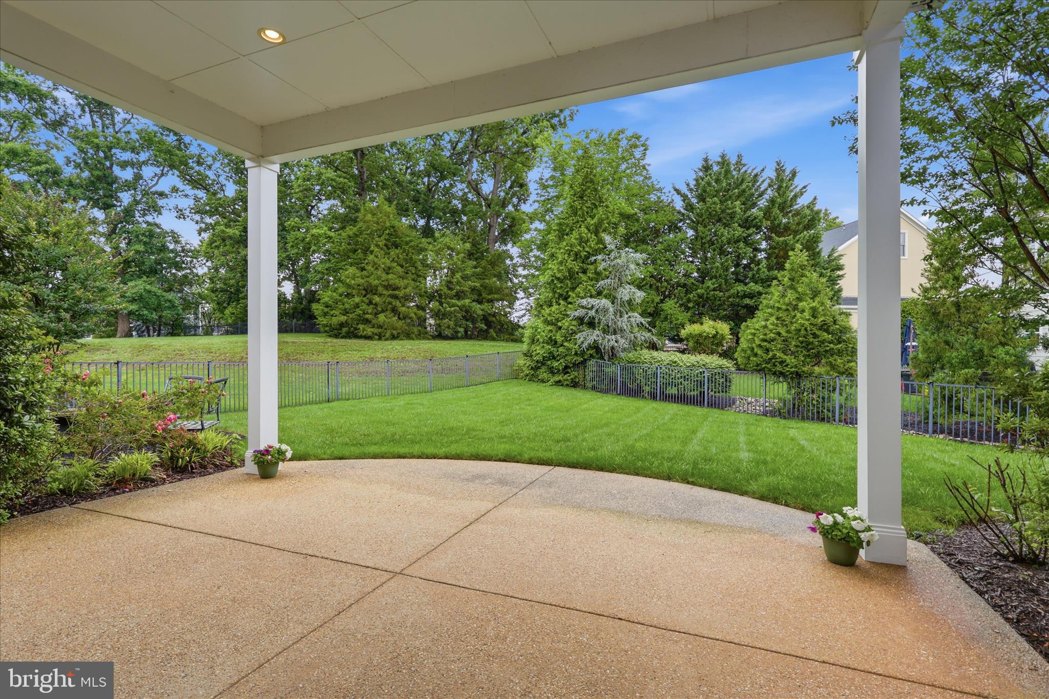 8277 Roxborough Loop Gainesville, VA 20155 - Photo 50 of 84 Outdoor Covered Patio Overlooking Treed Yard