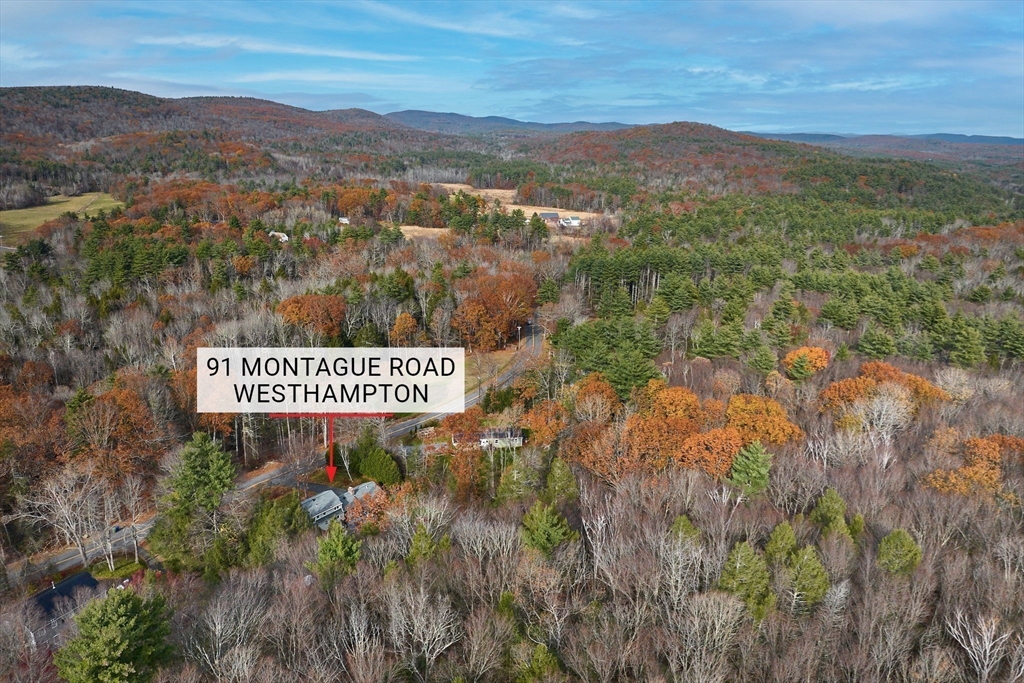 91 Montague Road Westhampton, MA 01027 - Photo 31 of 41 a view of a street sign under a large mountain view