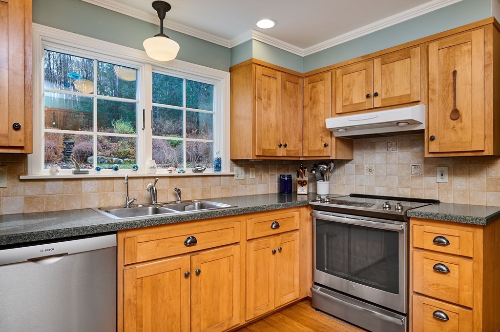 91 Montague Road Westhampton, MA 01027 - Photo 7 of 41 a kitchen with stainless steel appliances granite countertop a sink and cabinets with wooden floor