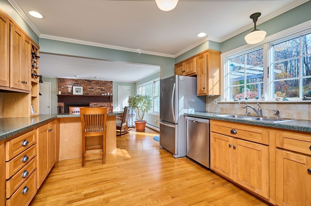 91 Montague Road Westhampton, MA 01027 - Photo 9 of 41 a open kitchen with stainless steel appliances granite countertop a refrigerator a sink dishwasher and white cabinets with wooden floor