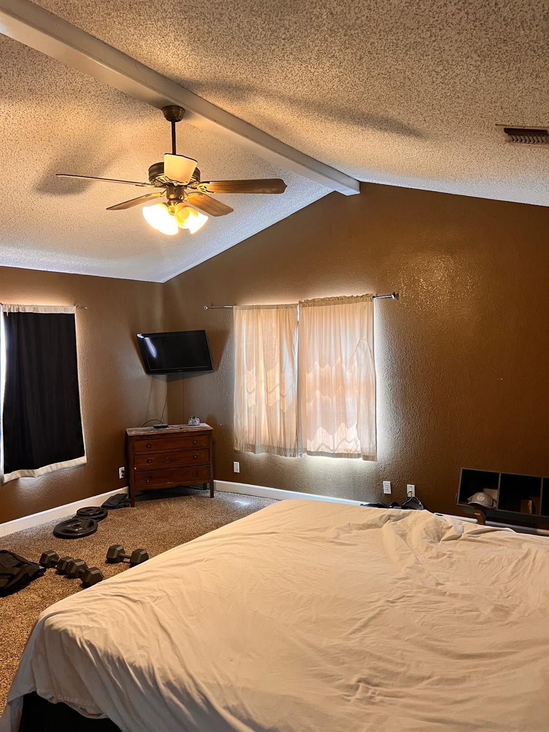 3598 Nightingale Road Ropesville, TX 79358 - Photo 17 of 22 a bedroom with a large bed and a chandelier