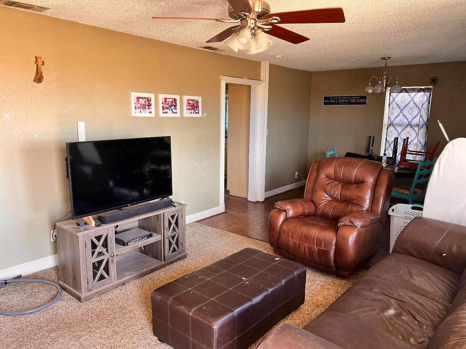 3598 Nightingale Road Ropesville, TX 79358 - Photo 19 of 22 a living room with furniture and a flat screen tv