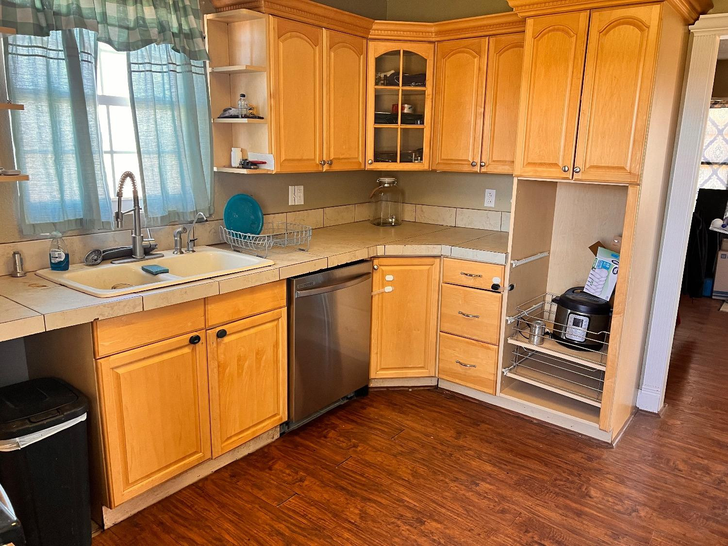 3598 Nightingale Road Ropesville, TX 79358 - Photo 9 of 22 a kitchen with stainless steel appliances granite countertop a sink and cabinets with wooden floor