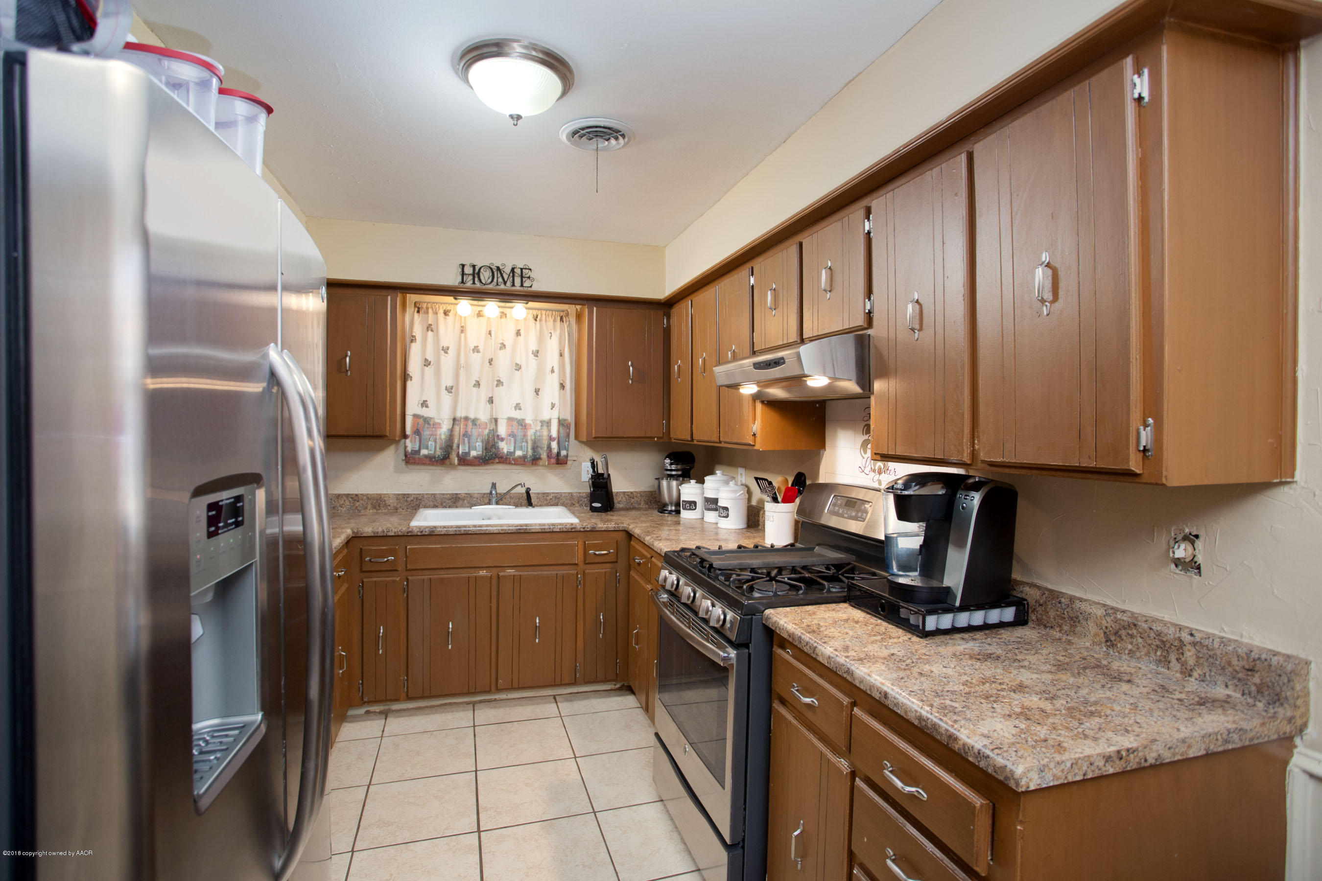 5328 Capulin Lane Amarillo, TX 79110 - Photo 6 of 17 a kitchen with a sink stove and refrigerator