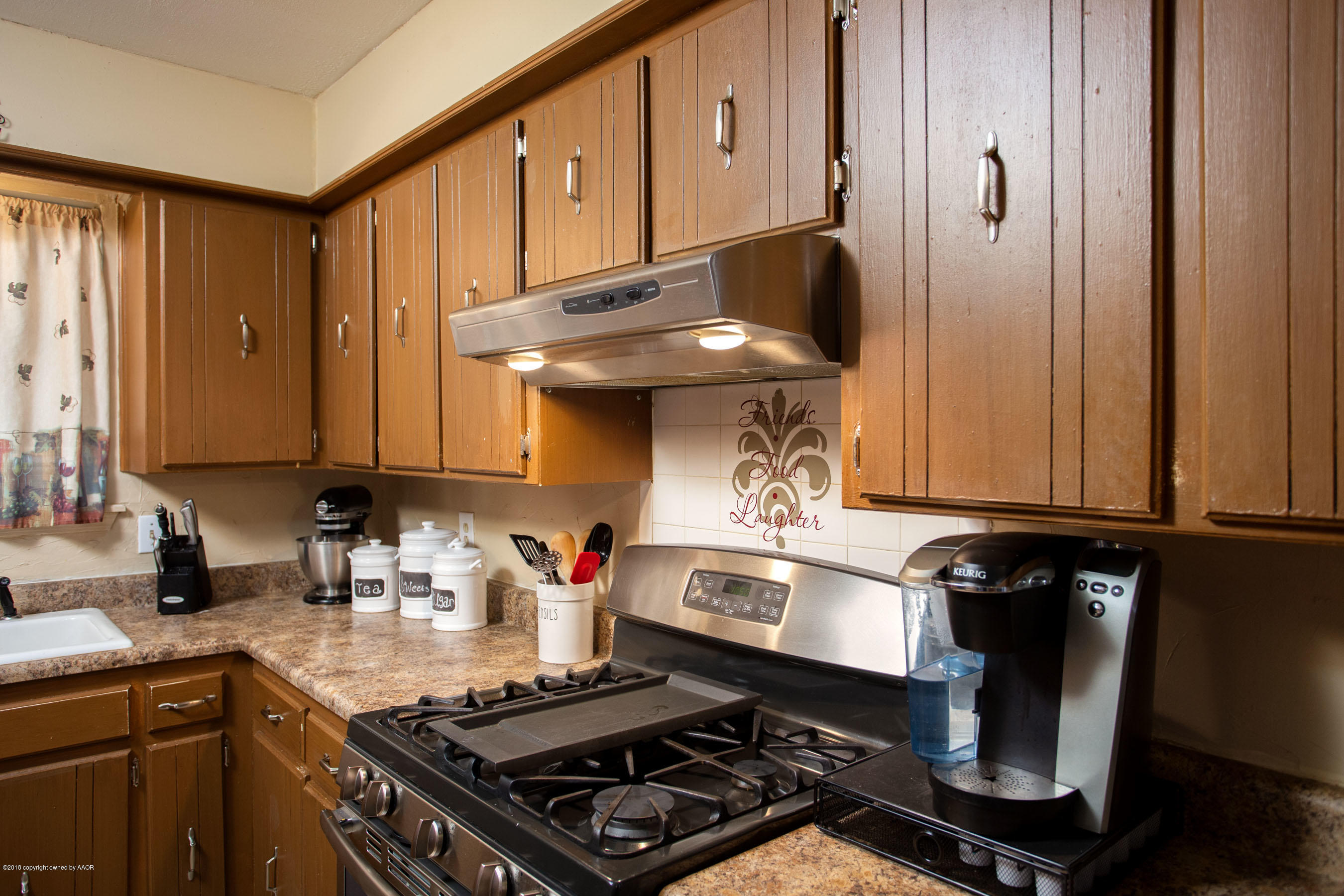 5328 Capulin Lane Amarillo, TX 79110 - Photo 7 of 17 a kitchen with a stove and cabinets