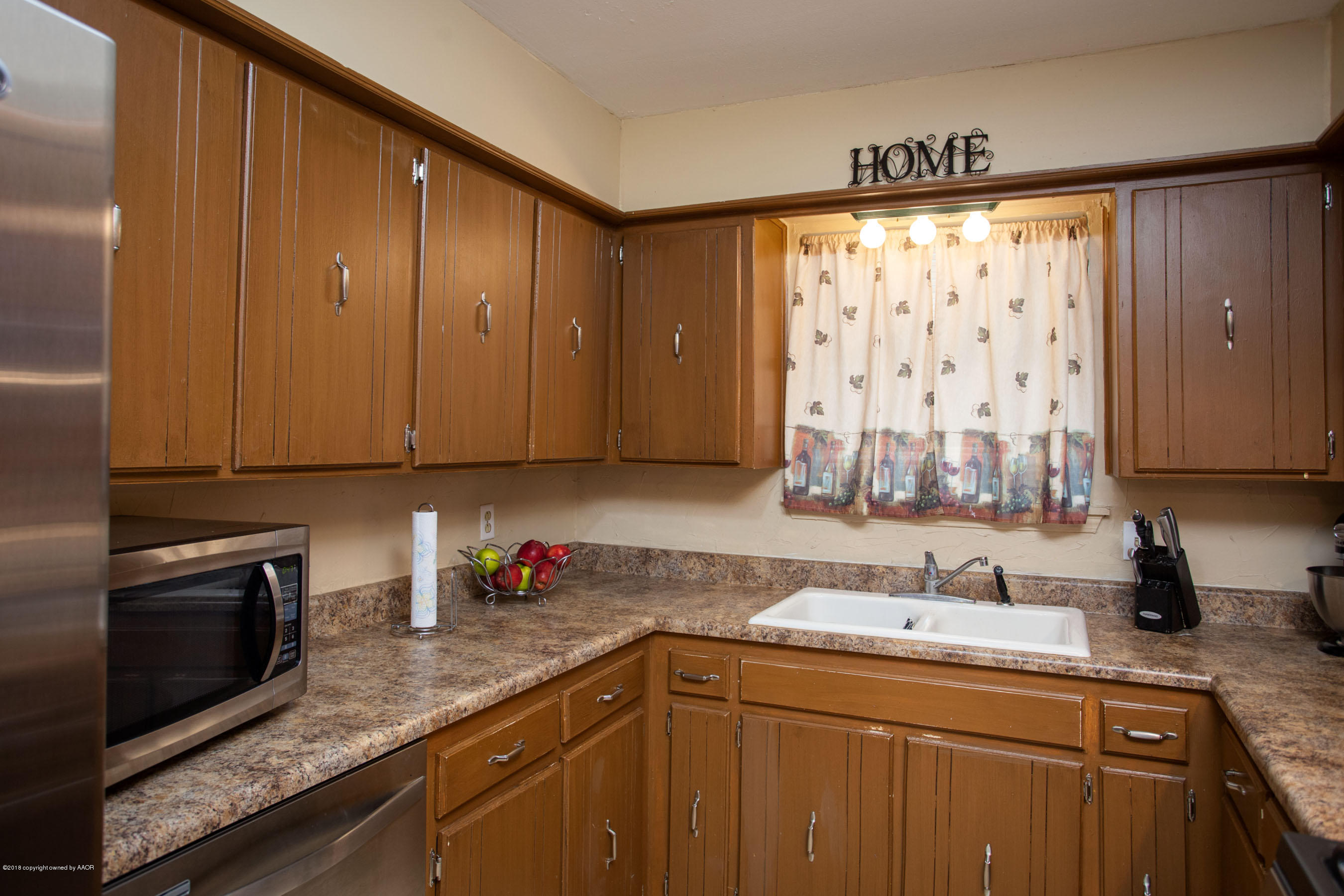5328 Capulin Lane Amarillo, TX 79110 - Photo 8 of 17 a kitchen with stainless steel appliances granite countertop a sink a stove and cabinets