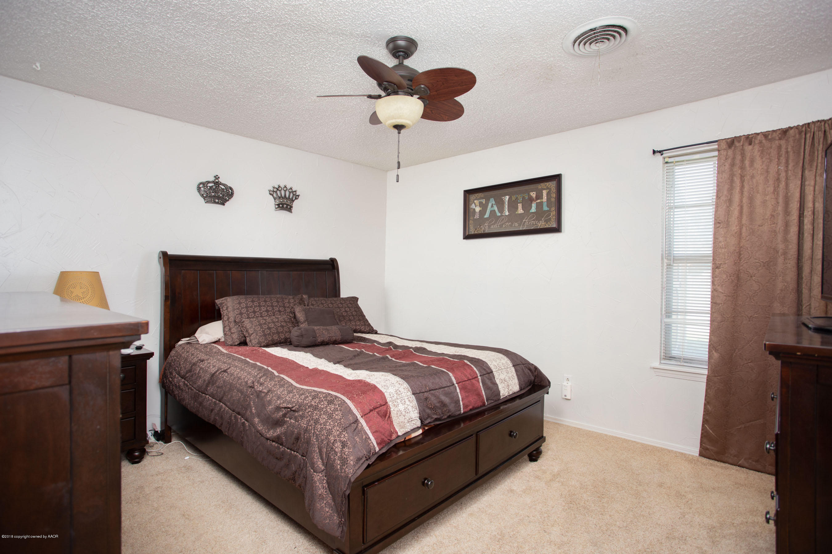 5328 Capulin Lane Amarillo, TX 79110 - Photo 10 of 17 a bedroom with a bed and a table