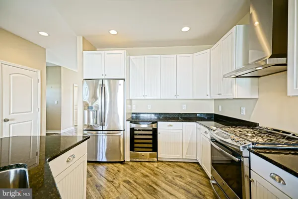a bathroom with a granite countertop sink a toilet and shower