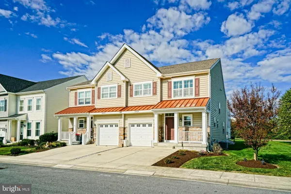a front view of a residential apartment building with a yard