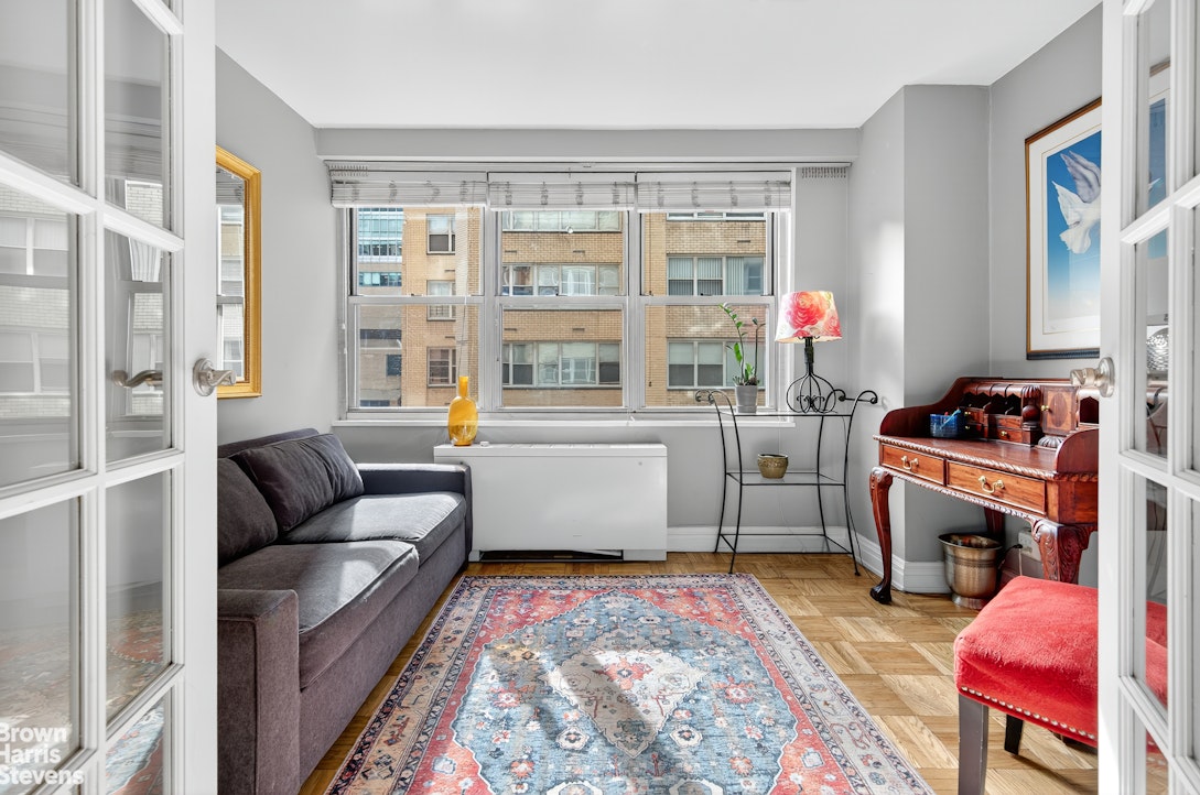 520 East 72nd Street, Unit 3F Manhattan, NY 10021 - Photo 2 of 15 a living room with furniture and a flat screen tv