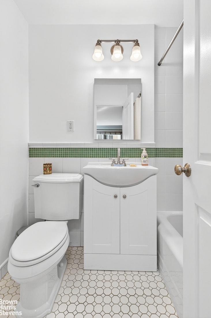 520 East 72nd Street, Unit 3F Manhattan, NY 10021 - Photo 7 of 15 a bathroom with a sink a toilet and mirror