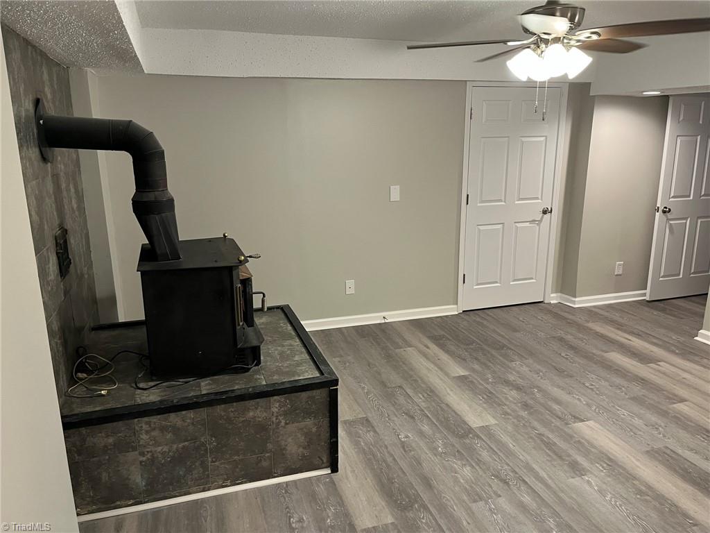 201 Jim Barr Road King, NC 27021 - Photo 28 of 33 Basement family room & wood stove
