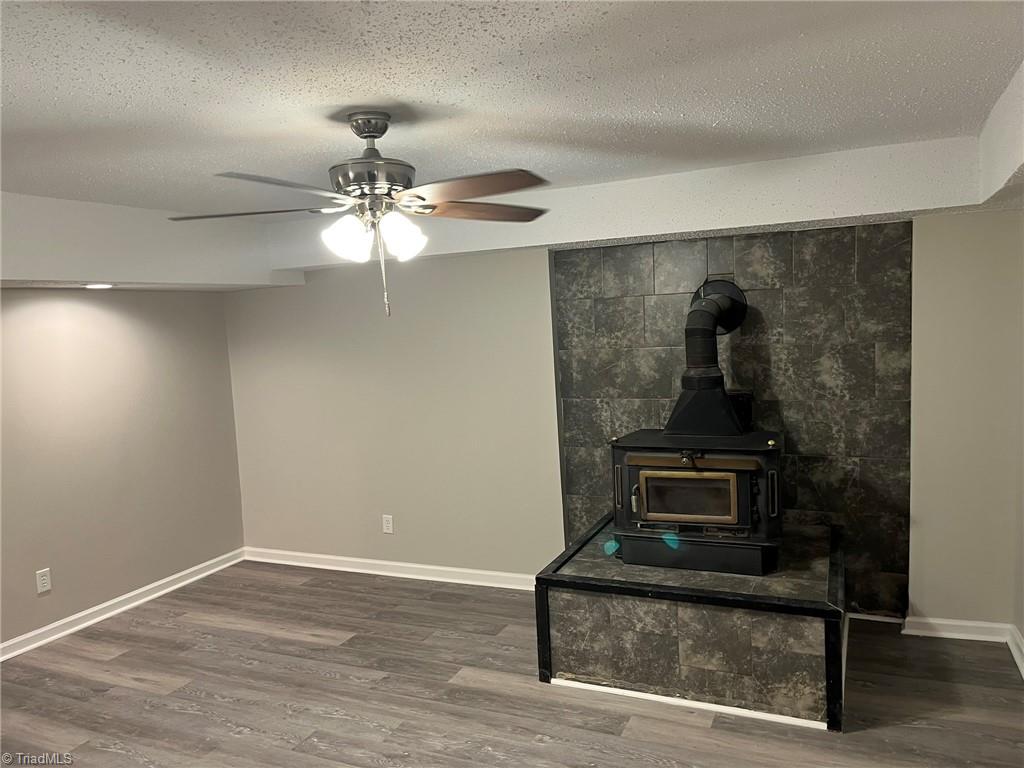 201 Jim Barr Road King, NC 27021 - Photo 29 of 33 Basement family room & wood stove