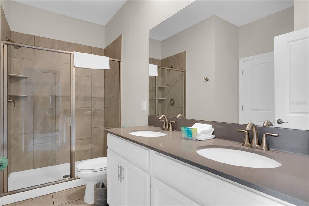4530 Narrative Lane Kissimmee, FL 34746 - Photo 14 of 98 a bathroom with a granite countertop sink mirror and double