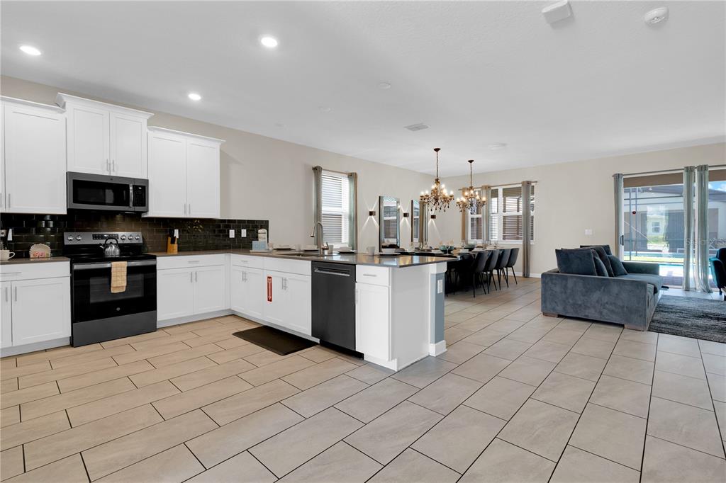 4530 Narrative Lane Kissimmee, FL 34746 - Photo 15 of 98 a kitchen with cabinets and a sink