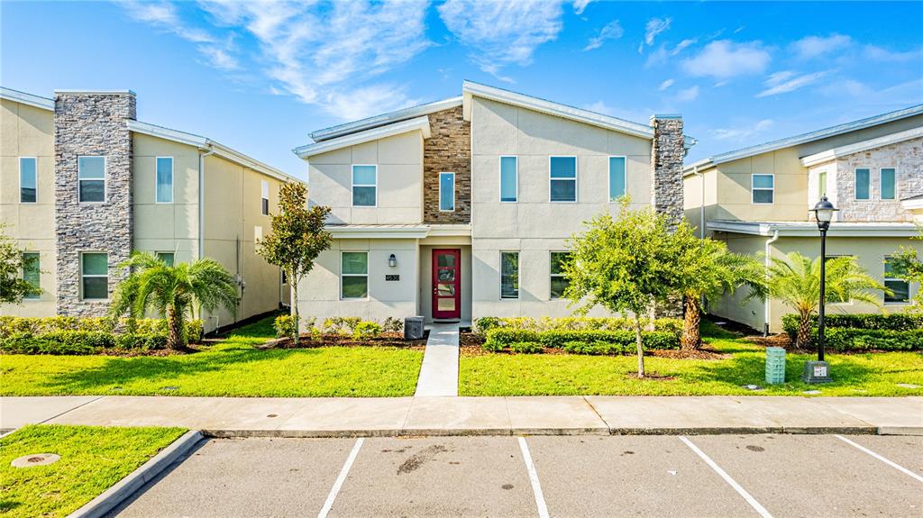 4530 Narrative Lane Kissimmee, FL 34746 - Photo 2 of 98 a front view of a house with a yard and potted plants