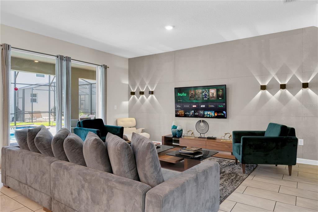 4530 Narrative Lane Kissimmee, FL 34746 - Photo 21 of 98 a living room with furniture and a flat screen tv