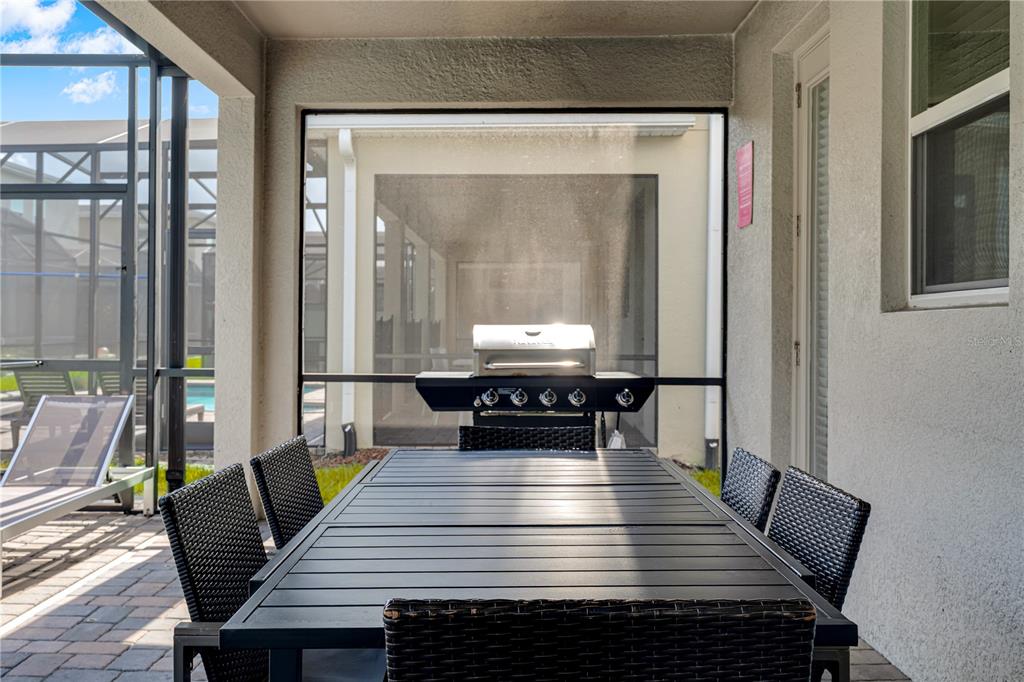 4530 Narrative Lane Kissimmee, FL 34746 - Photo 30 of 98 a dining room with furniture and wooden floor